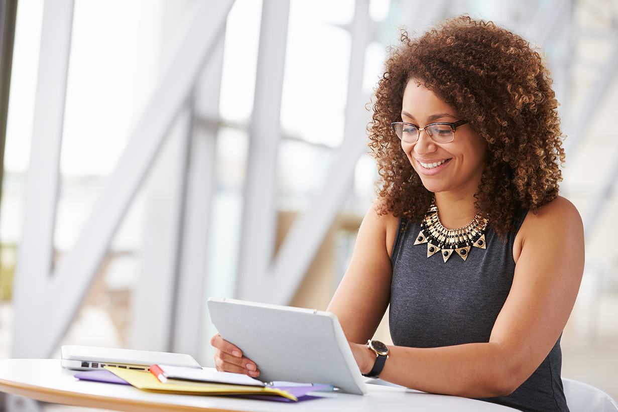 woman looking at tablet